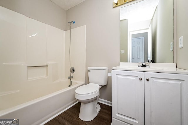 full bathroom with vanity, toilet, hardwood / wood-style flooring, and tub / shower combination