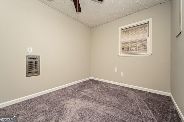 spare room featuring carpet flooring, a textured ceiling, heating unit, and ceiling fan