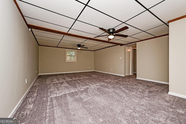 spare room featuring ceiling fan, carpet floors, and a paneled ceiling