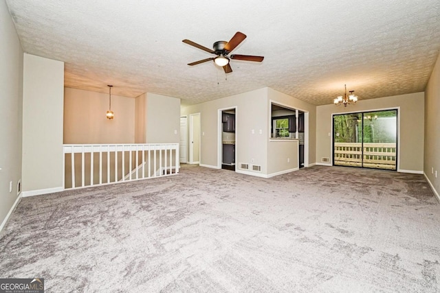 unfurnished living room featuring a textured ceiling and carpet floors