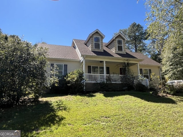 new england style home featuring covered porch and a front lawn