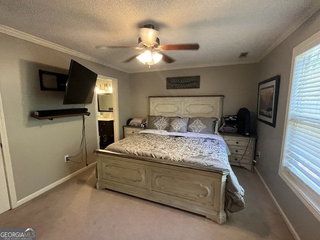 bedroom with ensuite bathroom, ornamental molding, light colored carpet, and ceiling fan