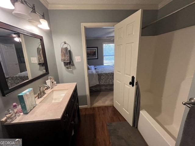 bathroom featuring vanity, ornamental molding, and wood-type flooring