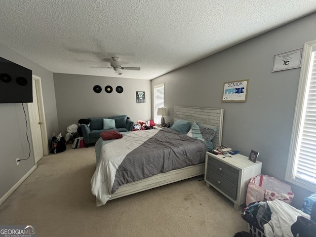 carpeted bedroom with a textured ceiling and ceiling fan