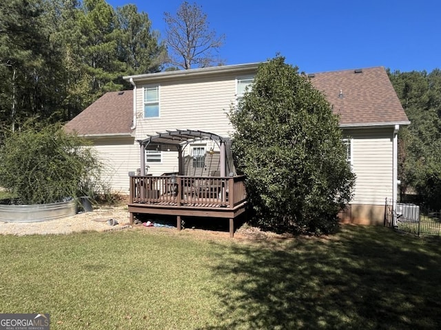 rear view of property featuring a pergola, a deck, and a yard