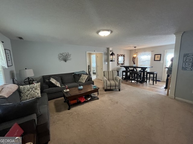 living room with a textured ceiling and carpet