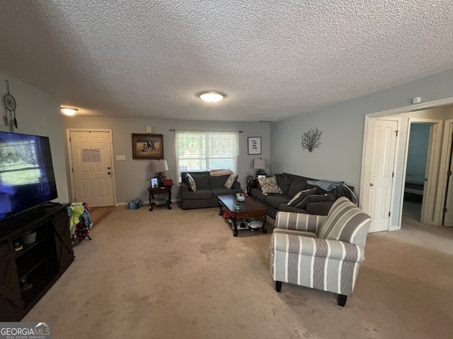 carpeted living room featuring a textured ceiling