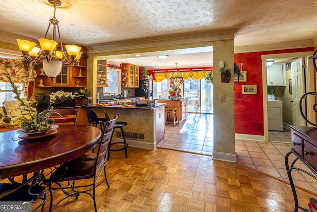 dining room with a textured ceiling, light parquet flooring, crown molding, and a notable chandelier