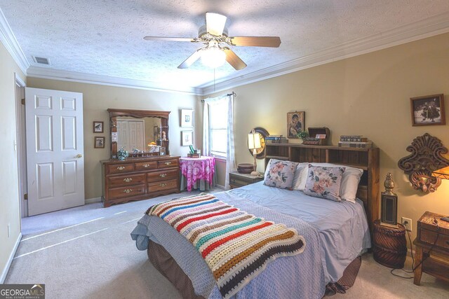 carpeted bedroom with ceiling fan, crown molding, a textured ceiling, and a closet