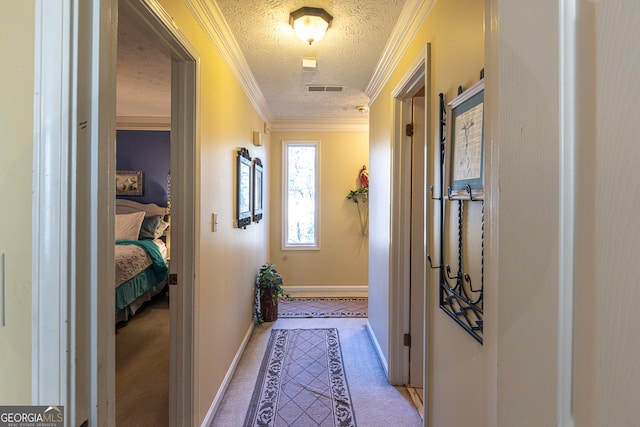 bedroom with ceiling fan, crown molding, light colored carpet, and a textured ceiling