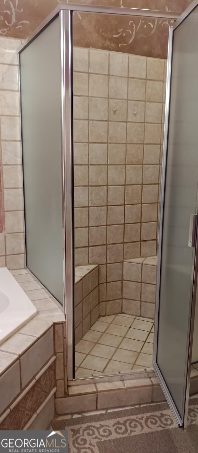 bathroom featuring a shower with shower door