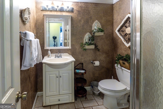 bathroom featuring tile patterned flooring, vanity, toilet, and ornamental molding