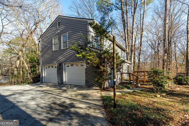 view of side of home with a deck and a garage