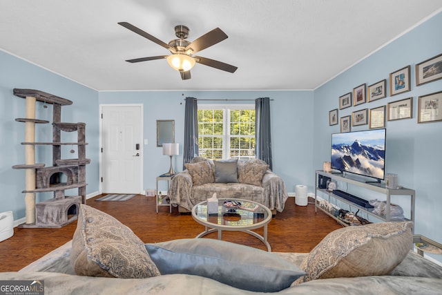 living room with dark hardwood / wood-style flooring, crown molding, and ceiling fan