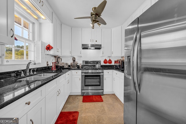 kitchen with appliances with stainless steel finishes, sink, and white cabinets