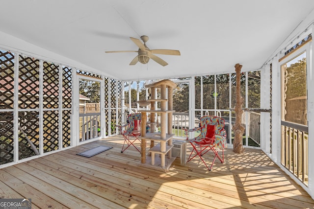 unfurnished sunroom with ceiling fan