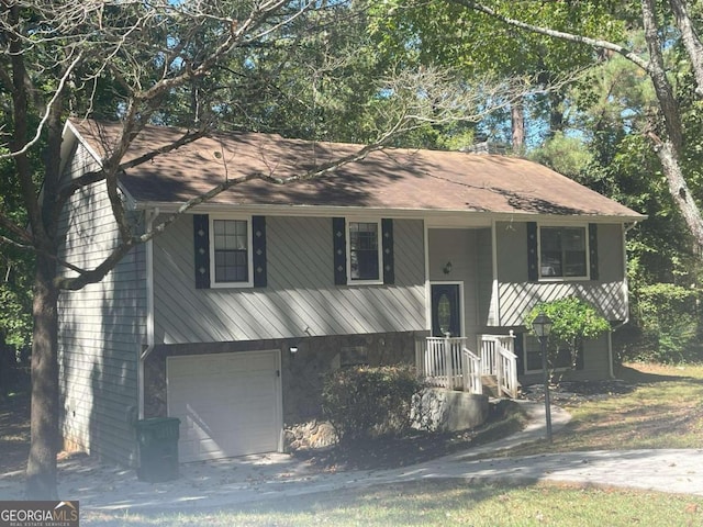 split foyer home featuring covered porch and a garage