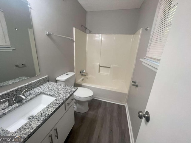 full bathroom featuring toilet, shower / bath combination, hardwood / wood-style floors, vanity, and a textured ceiling