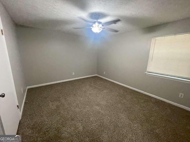 carpeted empty room featuring a textured ceiling and ceiling fan