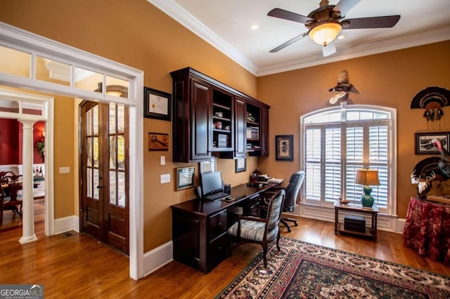 office space with dark wood-type flooring, ornate columns, ornamental molding, and french doors