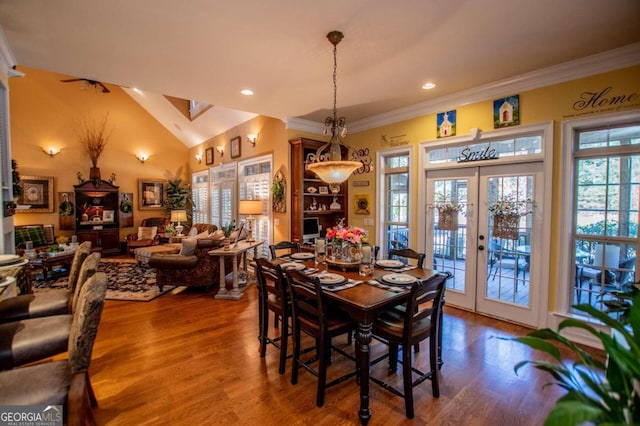 dining area featuring ornamental molding, french doors, vaulted ceiling, and hardwood / wood-style flooring