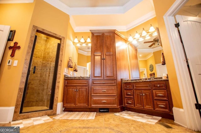 bathroom with vanity, ceiling fan, ornamental molding, and a shower with door