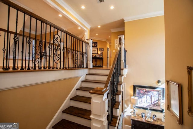 staircase featuring ornamental molding