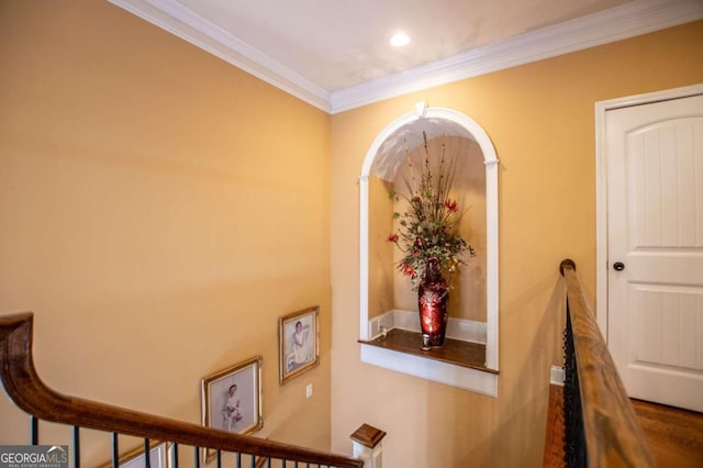 corridor featuring ornamental molding and wood-type flooring