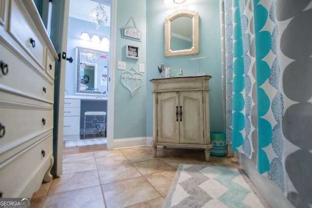 bathroom with vanity, ornamental molding, a shower with shower curtain, and tile patterned flooring