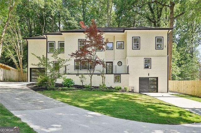 view of front facade featuring a front yard and a garage