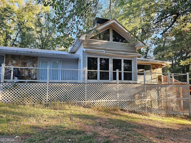 view of home's exterior featuring a wooden deck