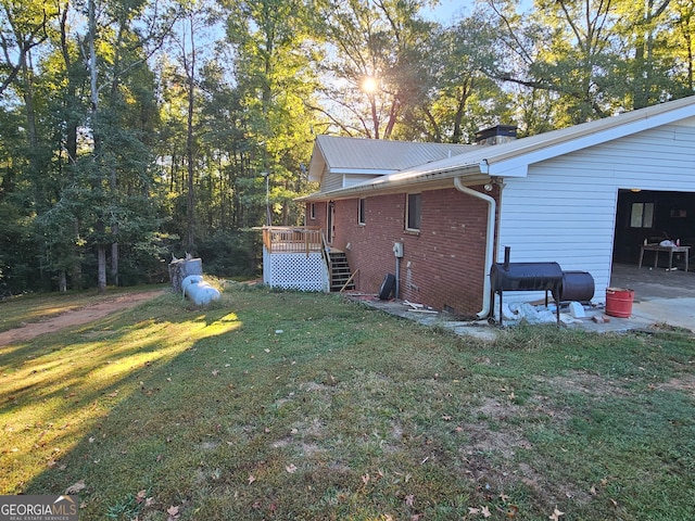 view of home's exterior with a deck and a lawn