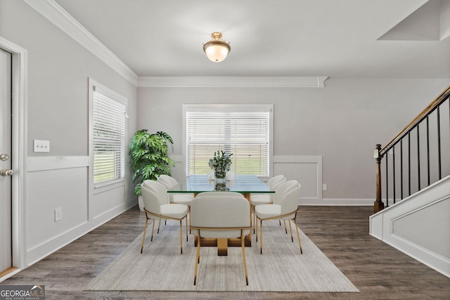 dining area with ornamental molding and dark hardwood / wood-style flooring