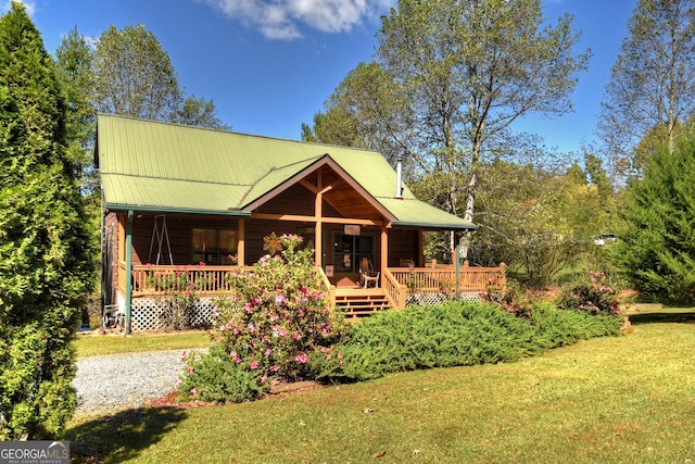 rear view of house with a yard and a wooden deck