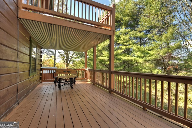 wooden terrace with a grill