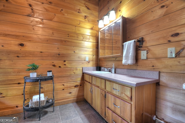 bathroom with vanity and wood walls