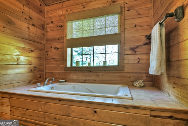 bathroom with wood walls and a bath