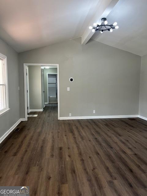 additional living space featuring lofted ceiling with beams, a chandelier, and dark hardwood / wood-style flooring