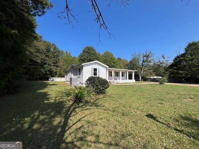 rear view of property with a lawn