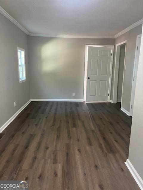 unfurnished living room with a chandelier, lofted ceiling with beams, and dark hardwood / wood-style floors