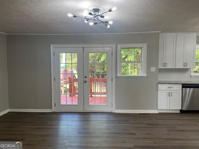 interior space with a notable chandelier, vaulted ceiling with beams, and dark hardwood / wood-style flooring