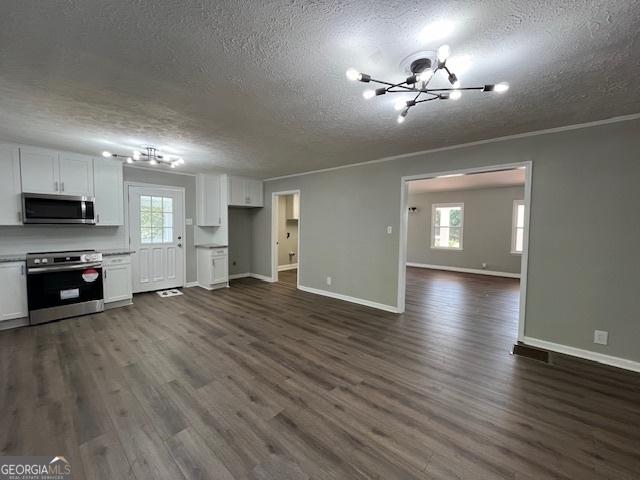 room details with decorative backsplash, black electric cooktop, white cabinetry, and light stone countertops