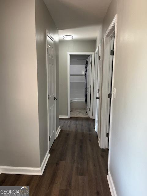 kitchen with a textured ceiling, stainless steel appliances, white cabinets, crown molding, and dark hardwood / wood-style floors