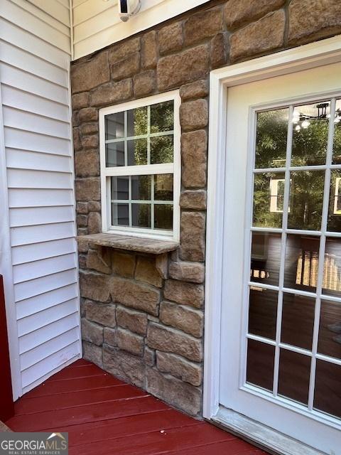 entrance to property with stone siding