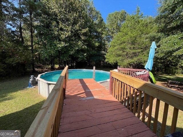 view of pool with a yard