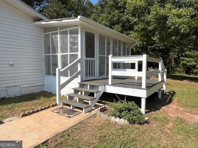 wooden deck with a sunroom