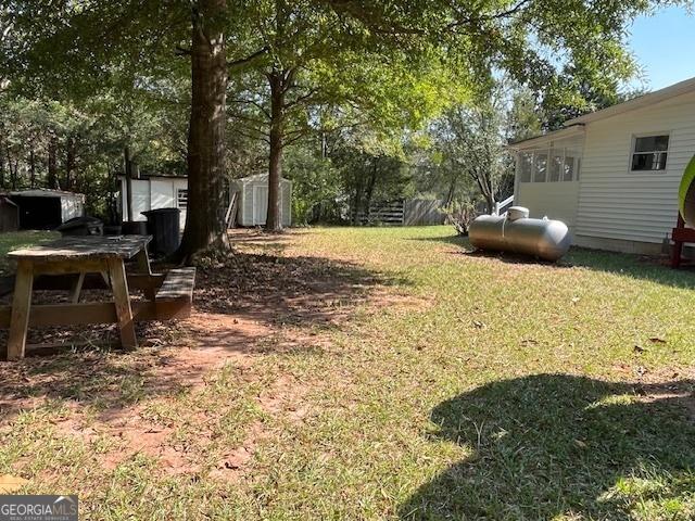 view of front of house with a sunroom, a deck, and a front yard