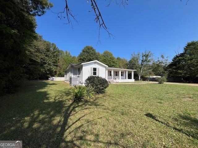 back of property featuring a lawn