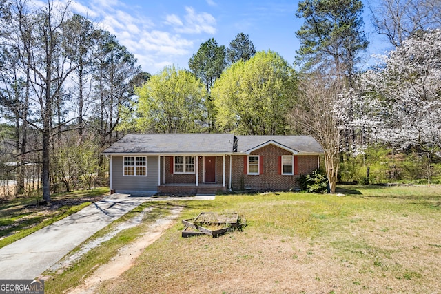 2420 Green Rd, Loganville, GA 30052 - ranch-style home featuring a porch and a front lawn