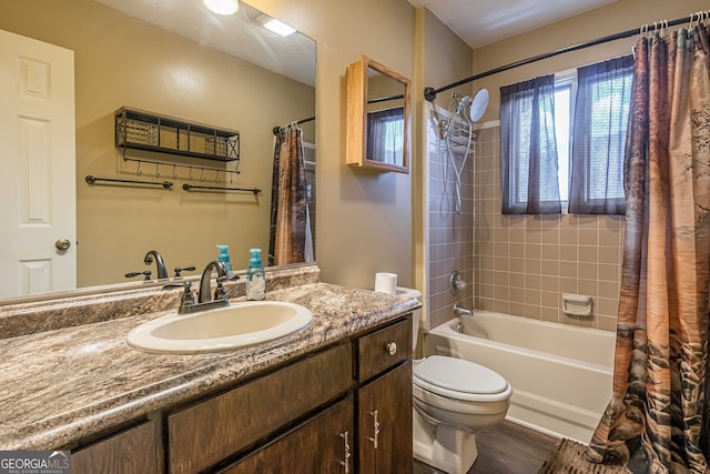 full bathroom with toilet, hardwood / wood-style flooring, vanity, and shower / tub combo